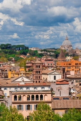Obraz premium Rome historic center old skyline above Trastevere with old churches, belltowers, domes and clouds, seen from Aventine Hill