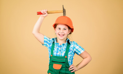 Little girl in helmet with hammer. Kid worker in hat. Labor day. 1 may. Foreman inspector. Repair. small girl repairing in workshop. Safety expert. Future profession. building is not for everyone