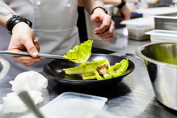 chef making salad in the restaurant