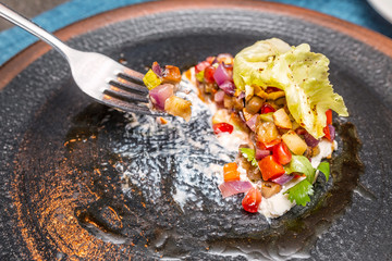 eating with fork tasty delicious salad on a dark plate