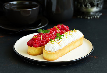 Lemon pie with meringue and raspberries.