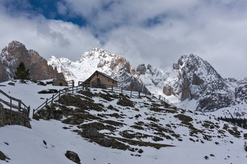 Hut refugio in winter landscape of the alps, Dolomites. Italy