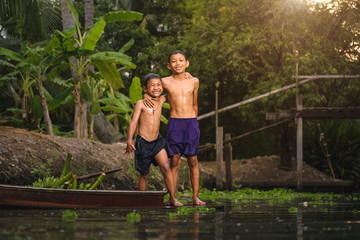 Boy swimming in the cannal near the Damnoen Saduak Floating Market