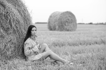 young free woman in a field with hay