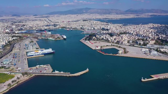 Aerial drone video of crowded port of Piraeus, one of the largest in Europe, where cruise and passenger ships travel to popular Aegean destinations, Attica, Greece