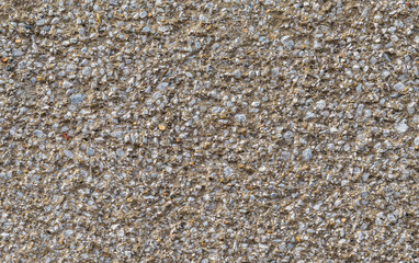 Concrete wall with gravel rough surface as background