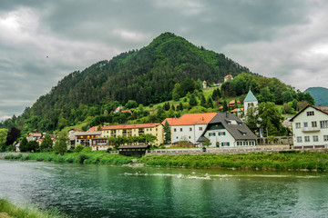 Fototapeta na wymiar LASKO, SLOVENIA, 2019.08.15: View from city bridge towards hill with city castle