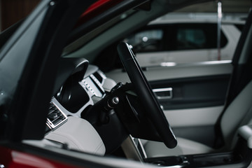 selective focus of black steering wheel in modern automobile
