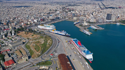 Obraz premium Aerial drone bird's eye view of famous crowded port of Piraeus one of the largest in Europe where ships travel to popular Aegean destinations, Attica, Greece