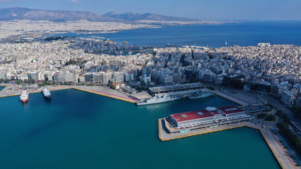 Aerial drone bird's eye view of famous crowded port of Piraeus one of the largest in Europe where ships travel to popular Aegean destinations, Attica, Greece