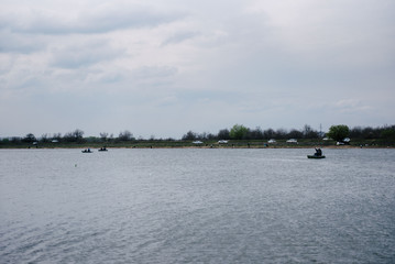 Fishermen on boats catch fish on the river