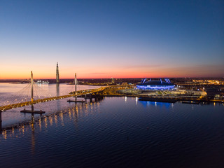Obraz premium Saint-Petersburg, Russia. Aerial views to Gulf Finland. Skyscraper Lakhta center Gazprom headquarters. Stadium Zenith Arena at night. Illuminated by multi-colored lights the stadium at night.