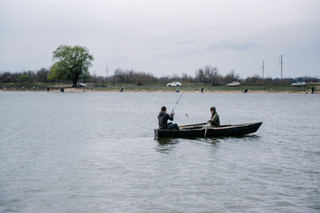 Fototapeta na wymiar Fishermen catch fish sitting in the boat