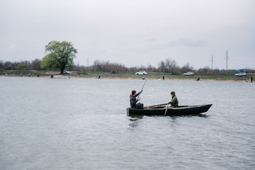 Fototapeta na wymiar Fishermen catch fish sitting in the boat