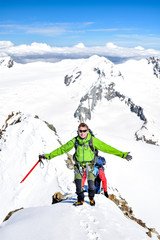 Fototapeta na wymiar Stunning winter outdoor mountain shot of an extreme hiker with an ice axe near the summit of Aletschhorn mountain (4193m above sea level) in the Jungfrau-Aletsch region of the Alps in Switzerland.