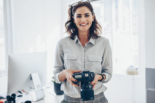 Attractive young woman photographer - Powered by Adobe