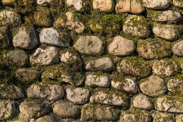 Old moss covered stone wall - beautiful vintage background