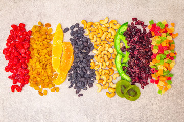 Dried and candied fruit and cashew nuts. Assorted on a stone background. Healthy vegetarian (vegan)...