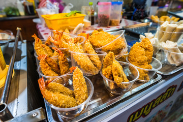 breaded fried shrimps in plastic cups at the street market