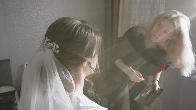 makeup artist girl preparing for the wedding bride