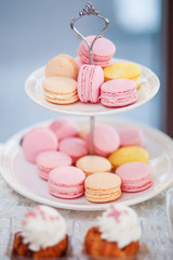 delicious pink and yellow macaroons on stander