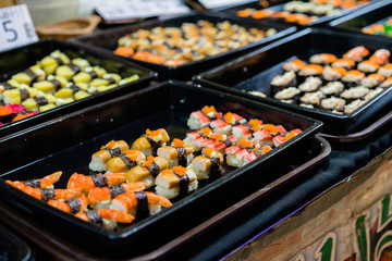 sushi and sashimi sets in black plastic trays 