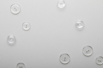 top view of transparent clothing buttons isolated on grey with copy space