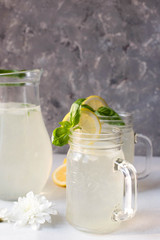 refreshing cocktail with lemon and ice. Summer. Lemonade. Flowers. Glass. Mint.
