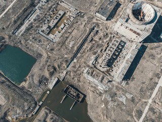Aerial view from drone of abandoned and ruined Nuclear Power Plant or station, round tower of...