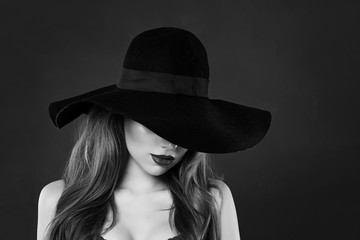 Beautiful model in classic hat, black and white portrait