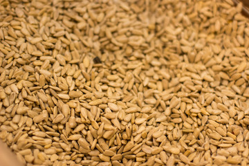 peeled seeds cereals food textured background in supermarket counter by weight 