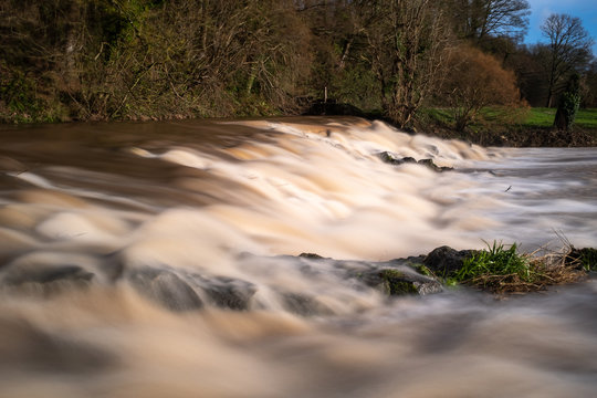 The weir at Tipton St John on the River Otter at full force with all the rain following Storm Gareth, long exposure to smooth out the water.