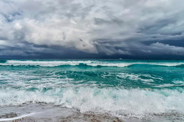 Fototapeta na wymiar coast of the Atlantic Ocean during a storm, a white motor yacht on the horizon,