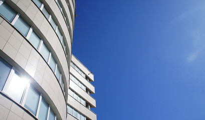 Modern office building against the blue sky. Background for business design.