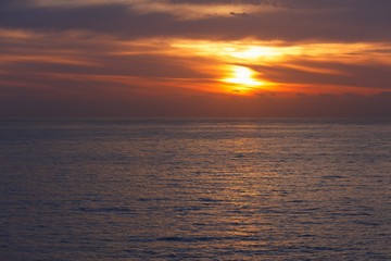 Naklejka na ściany i meble sunrise at ocean seascape with reflection