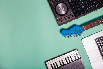 Fototapeta na wymiar musical instruments dj controller , midi controller, guitar end laptop on multicolors background 