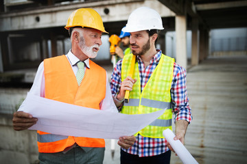 Construction engineer with foreman worker checking construction site