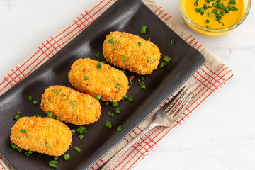 Potato Croquettes with Cheese Served with Mustard Sauce on White Background, Directly From Above,...