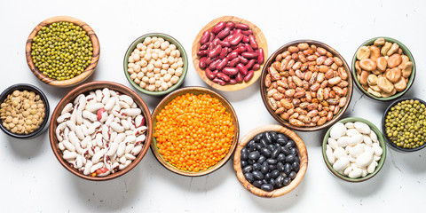 Legumes, lentils, chikpea and beans assortment on white.