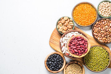 Legumes, lentils, chikpea and beans assortment on white.