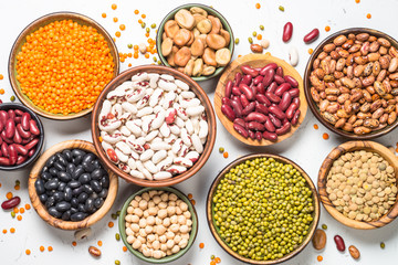 Legumes, lentils, chikpea and beans assortment on white.
