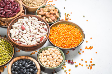 Legumes, lentils, chikpea and beans assortment on white.