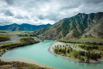 Picturesque view on the confluence of two mountain rivers. Katun river and Chuya river against of...