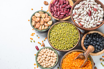 Legumes, lentils, chikpea and beans assortment on white.