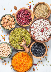 Legumes, lentils, chikpea and beans assortment on white.