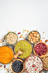Legumes, lentils, chikpea and beans assortment on white.