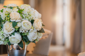 glass vase with white bouquet flower decprative items in living room home interior concept