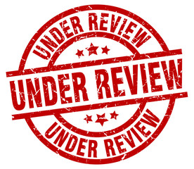 under review round red grunge stamp