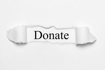 Fototapeta premium Donate on white torn paper
