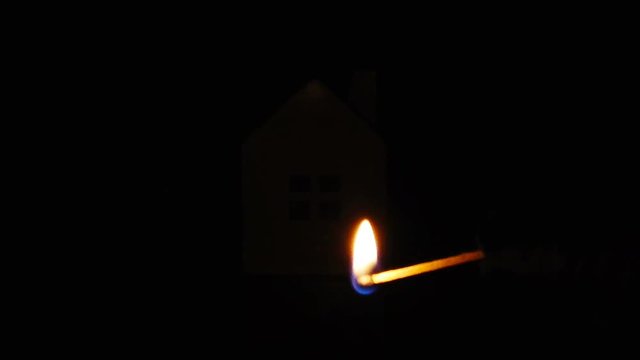 slow motion of arsonist igniting the gasoline around a house concept of house safety and insurance